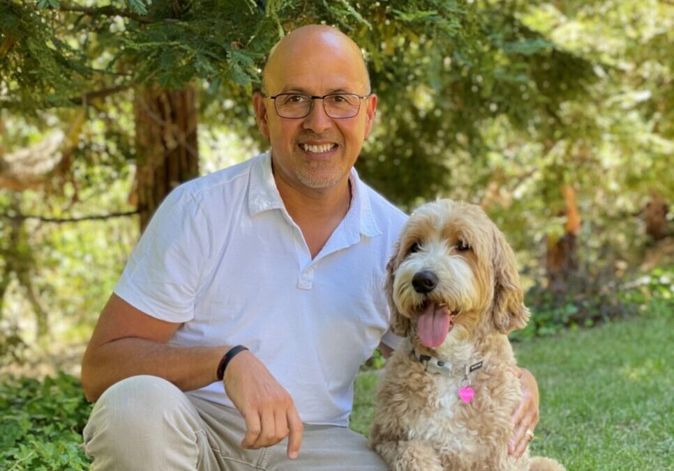 A man and his dog pose for the camera.